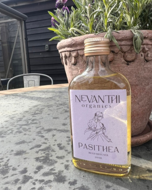 Pasithea reed diffuser 200ml by Nevanthi Organics — luxury lavender rosewood and bergamot home fragrance styled outdoors with terracotta pot and lavender plant