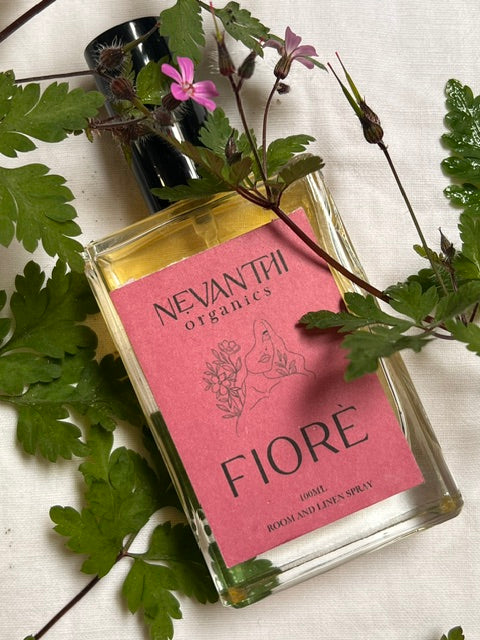 Fiore room and linen spray by Nevanthi Organics — 100ml floral home fragrance with red mandarin jasmine and ylang ylang styled with ferns and wild pink flowers on white linen