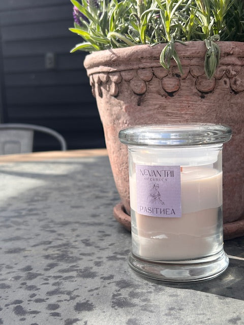 Pasithea soy wax candle by Nevanthi Organics — handmade wooden wick candle with lavender rosewood and bergamot styled outdoors with terracotta and lavender