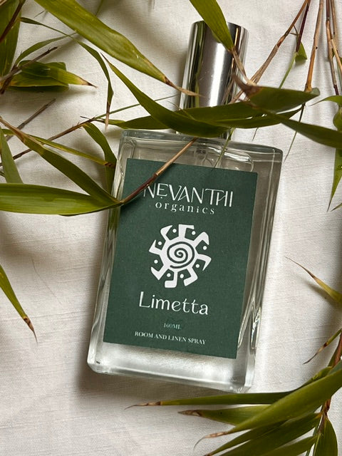 Limetta room and linen spray by Nevanthi Organics — 100ml summer seasonal citrus home fragrance with lime basil and red mandarin styled with bamboo leaves on white linen