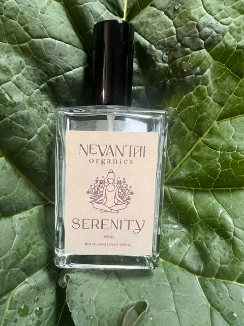 Serenity room and linen spray by Nevanthi Organics — luxury handmade UK home fragrance styled on large rhubarb leaf with water droplets