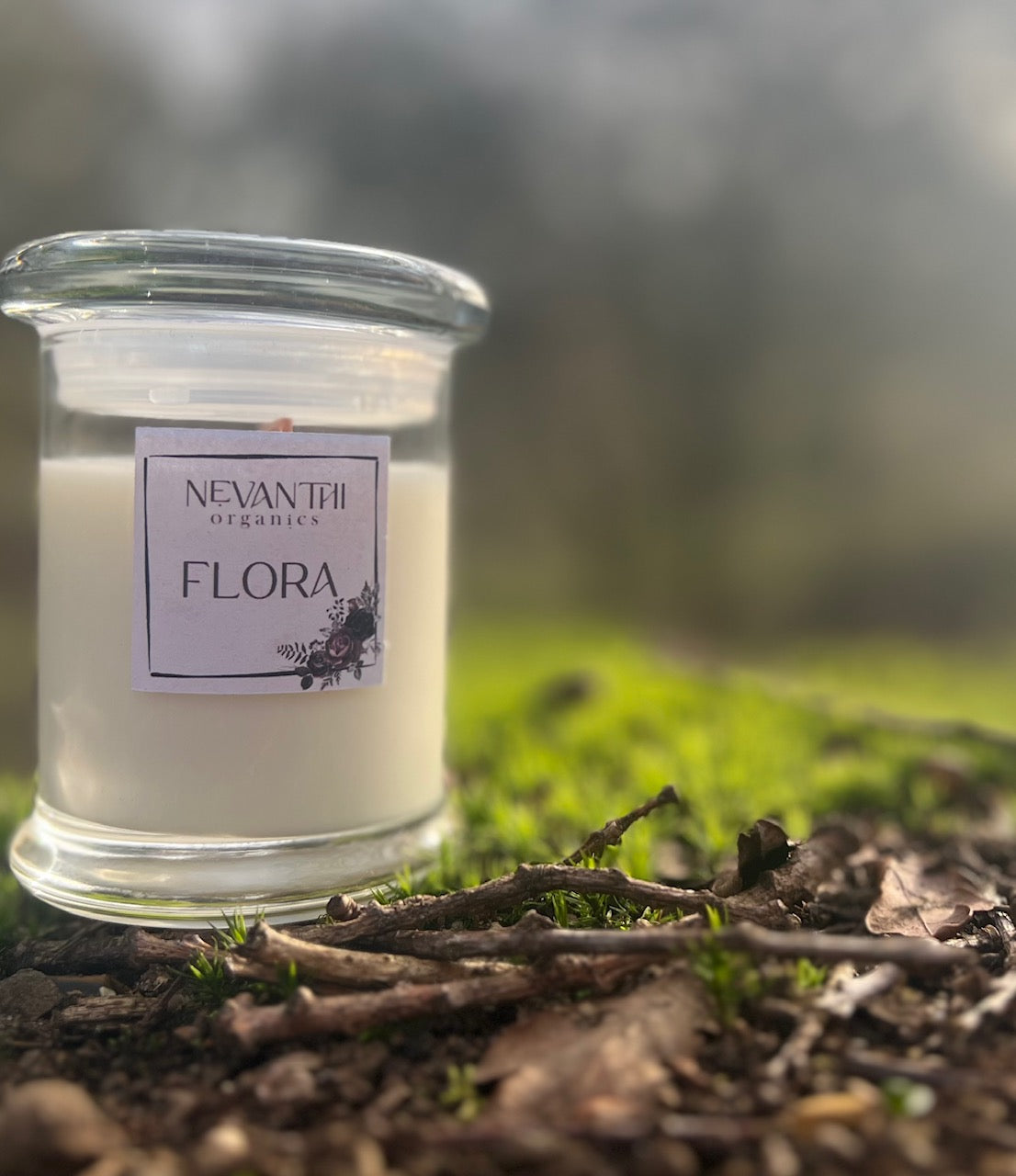 Flora soy candle by Nevanthi Organics — limited spring seasonal candle with lime blossom jasmine and vetiver photographed in Norfolk countryside